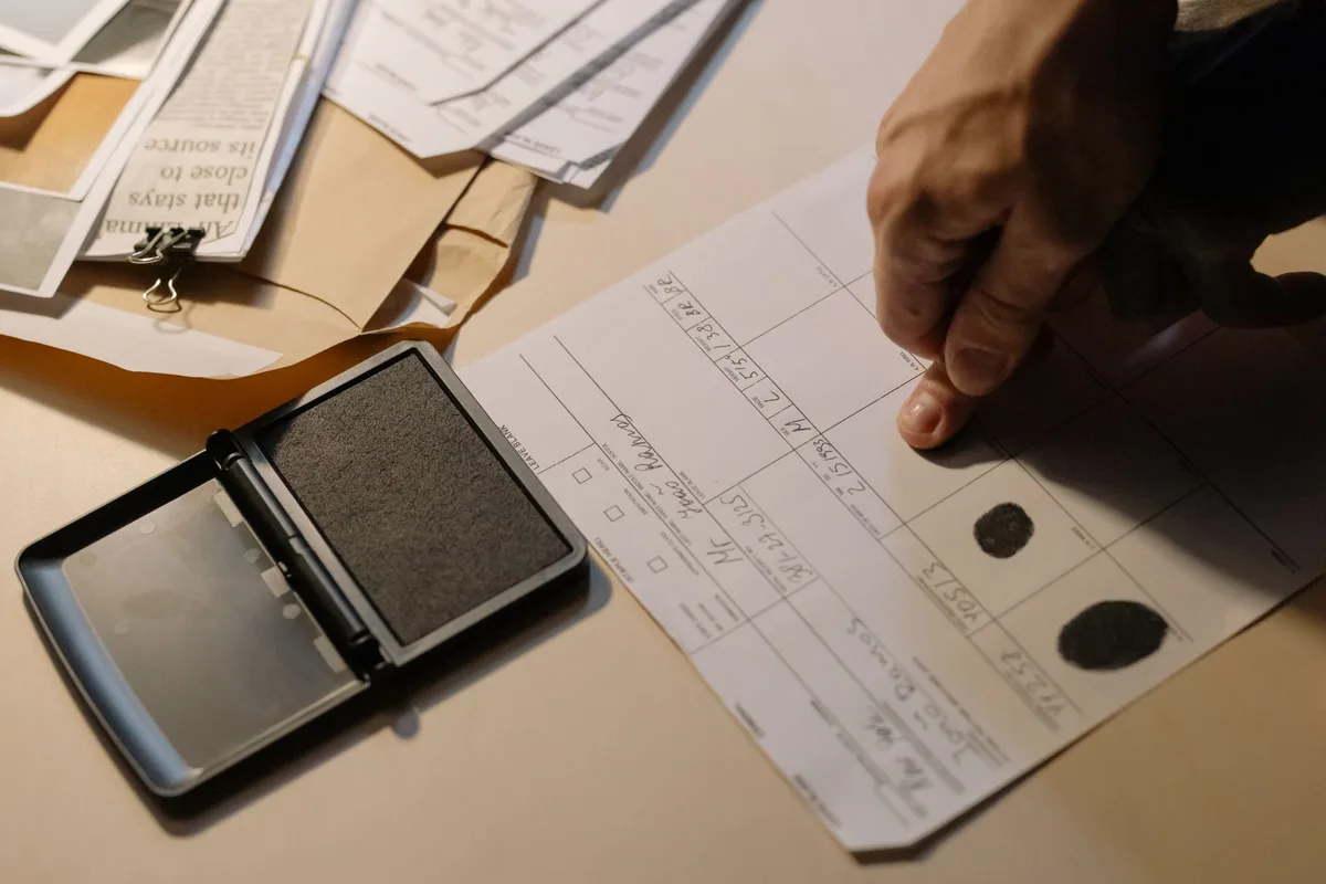 Documents and files spread on a desk, symbolizing oversight and background verification processes