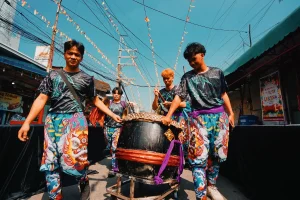 Vibrant street parade with colorful costumes and dancers celebrating in an urban neighborhood setting