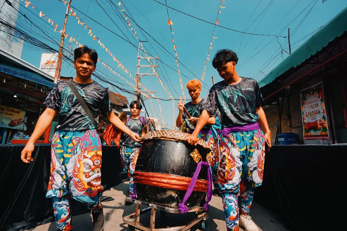 Vibrant street parade with colorful costumes and dancers celebrating in an urban neighborhood setting