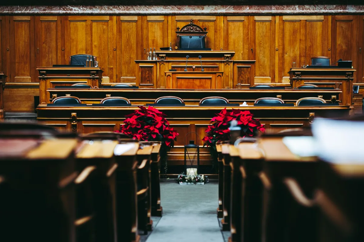Courtroom with judge's gavel and legal documents during a trial proceeding