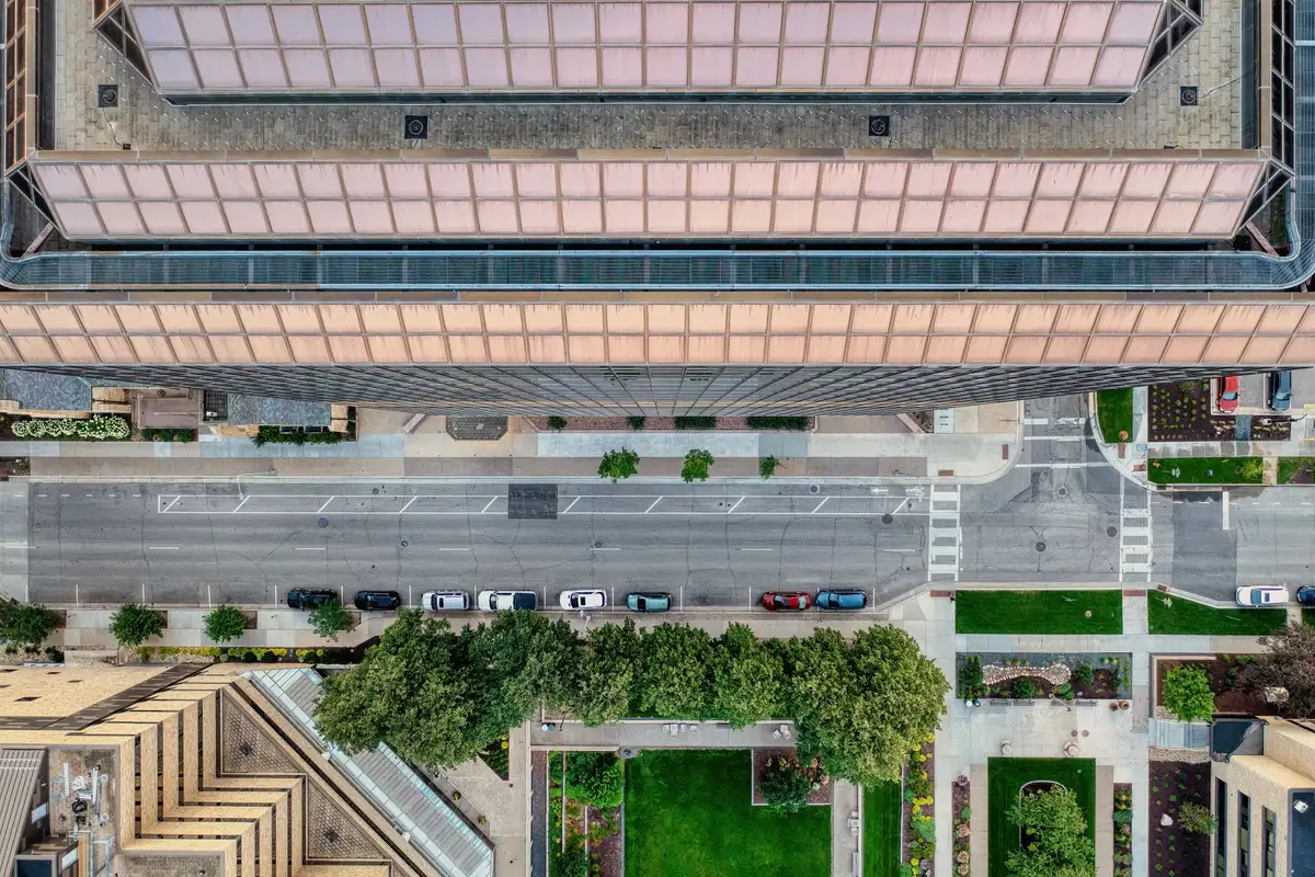 Modern cityscape with green spaces, pedestrian pathways, and sustainable urban infrastructure integrated throughout the