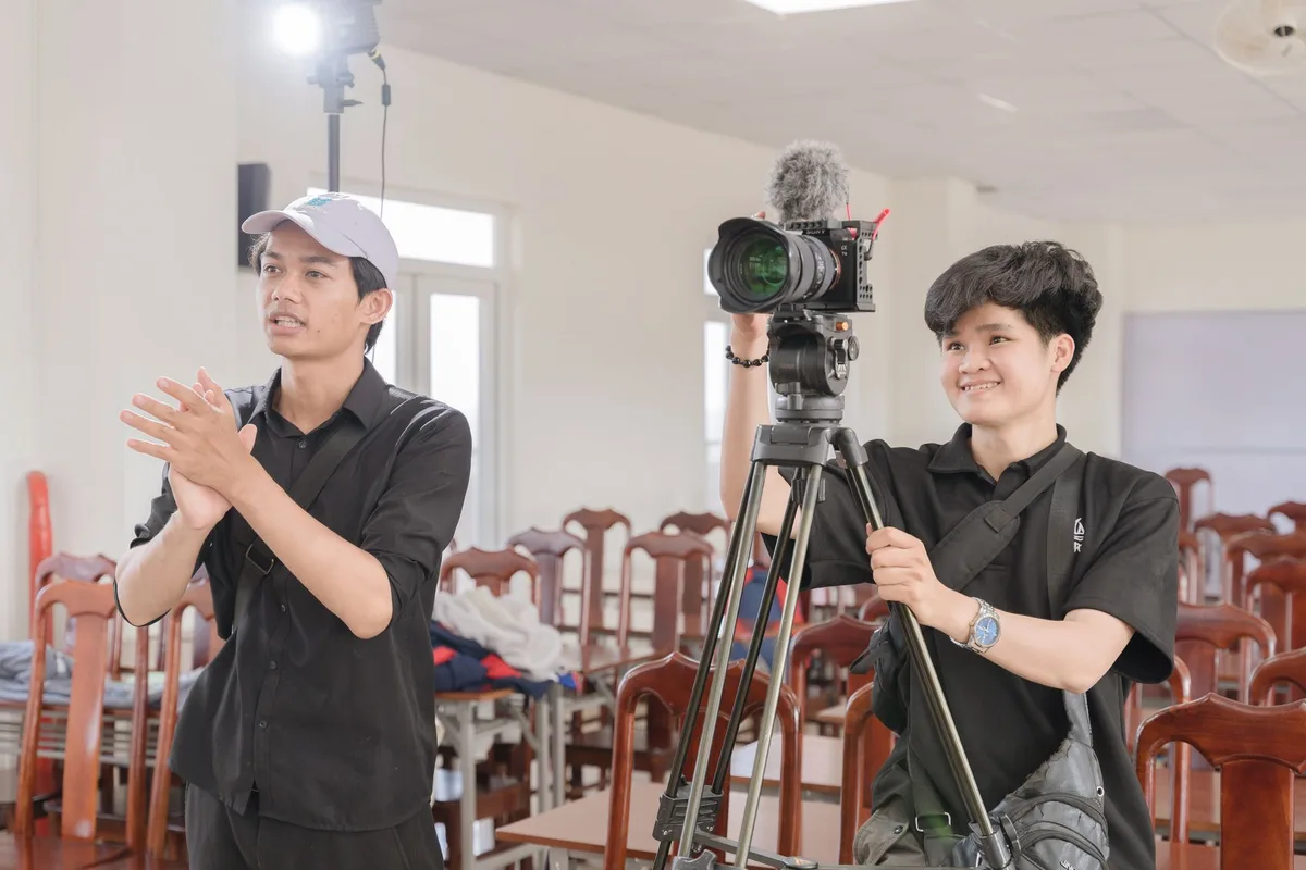 A young filmmaker in silhouette at a prestigious film festival venue, symbolizing the transition from student to industr
