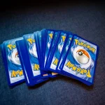 Hands opening sports card packs with cards fanning out in mid-air during a live session