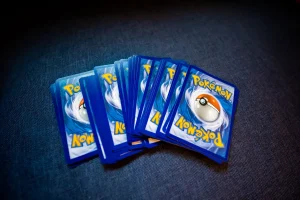 Hands opening sports card packs with cards fanning out in mid-air during a live session
