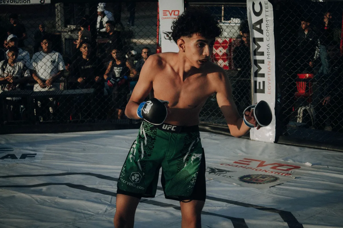 MMA fighter in striking stance demonstrating defensive footwork and positioning