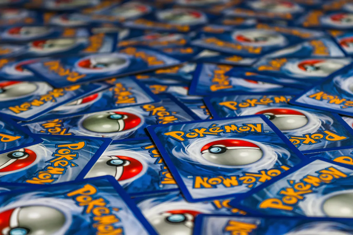 Hands opening trading card packs during a live stream box break event