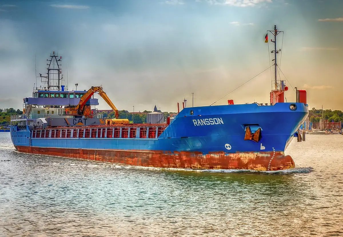 Cargo ships anchored near a narrow strait representing global trade routes