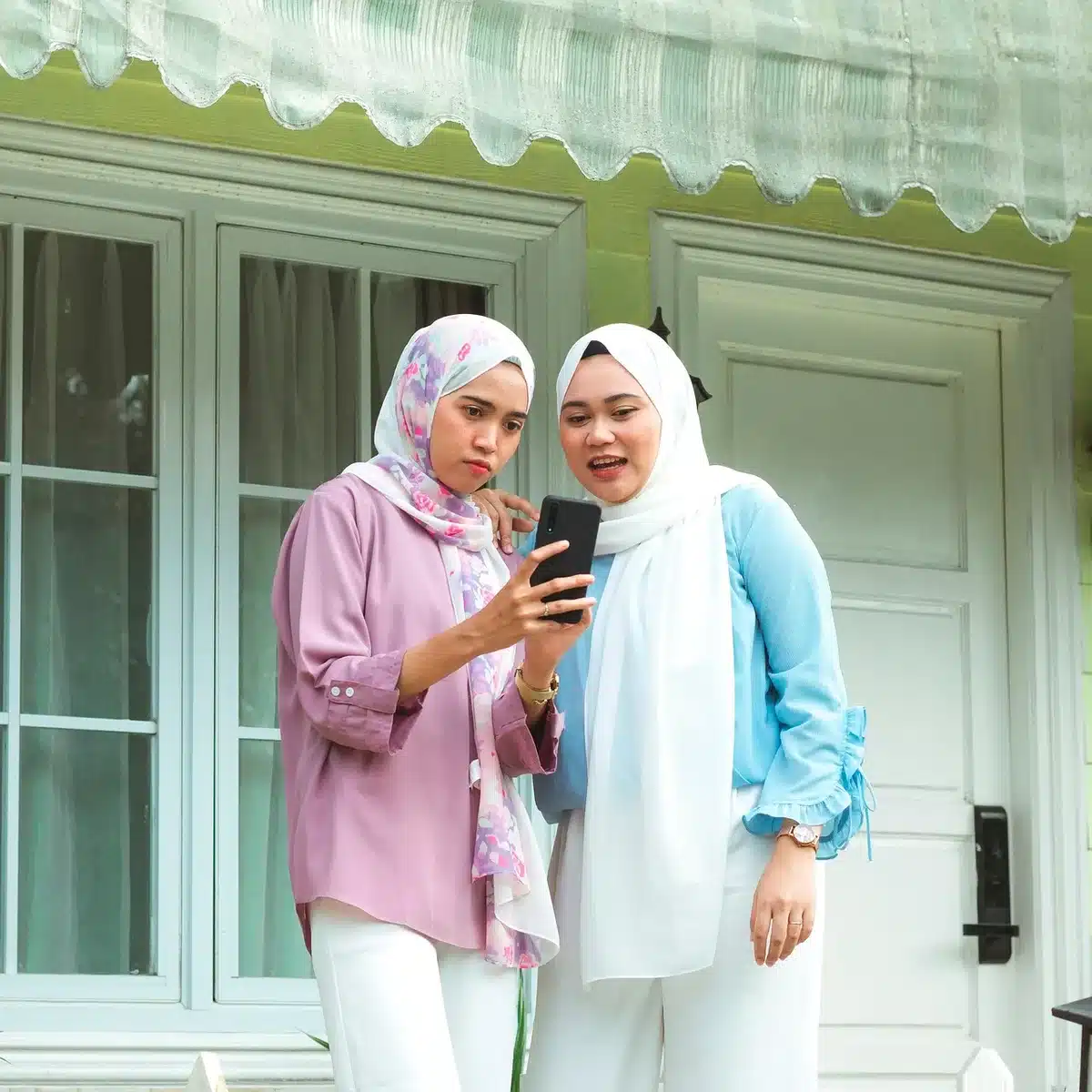 Women in an urban street with some not wearing hijab, symbolizing changed public behavior