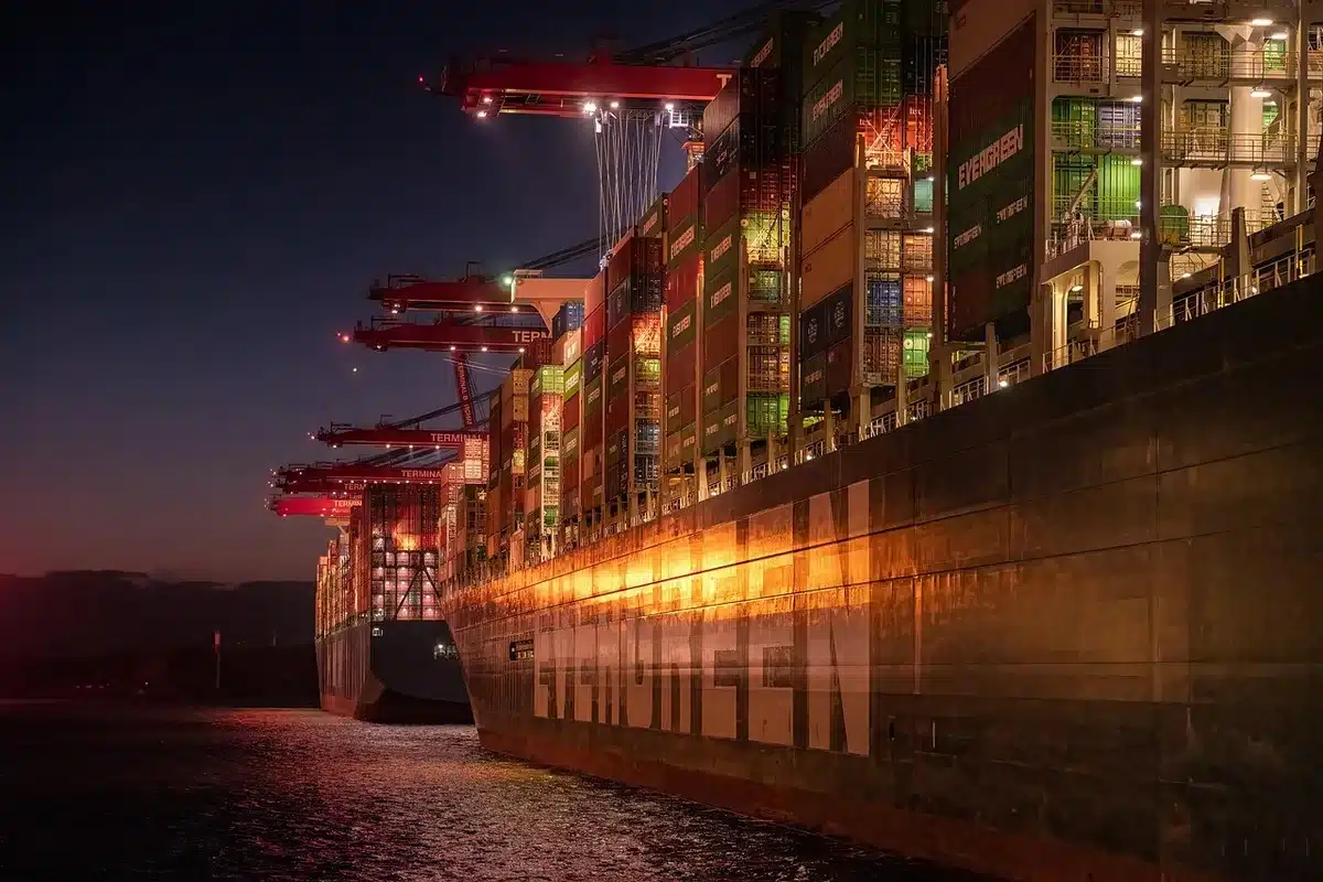 Cargo ships passing through a narrow strait representing Bab al-Mandab trade route