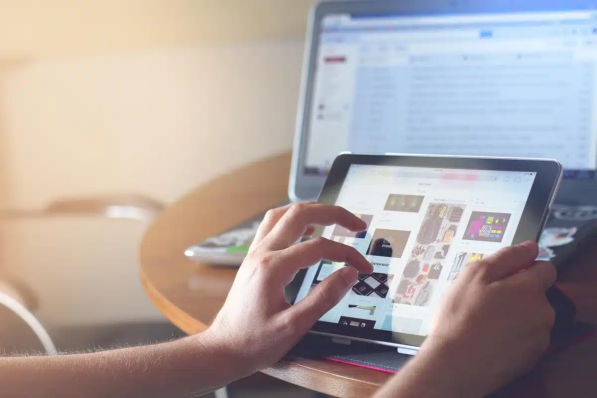 Person using a tablet with a streaming app interface on a couch