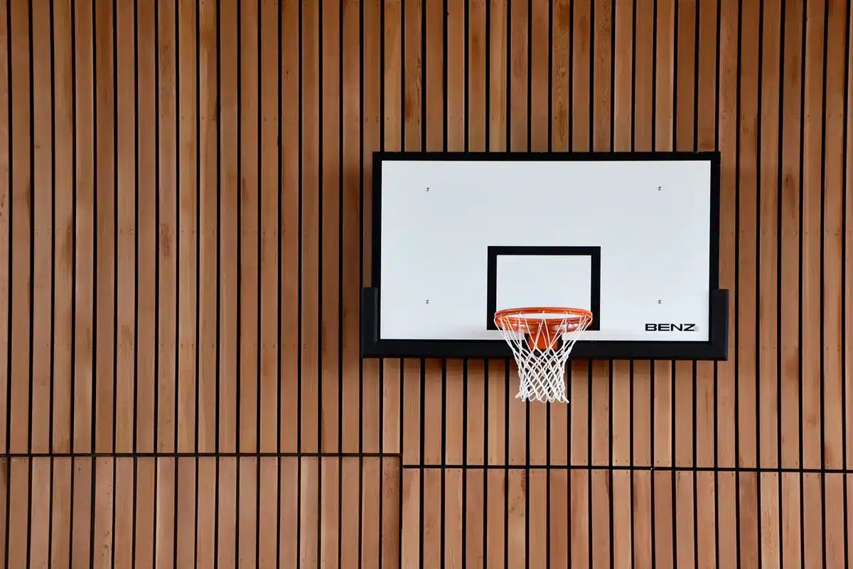 Empty basketball arena stands with security personnel in background