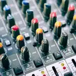Headphones with digital sound wave visualization on a dark background, representing AI-powered audio technology