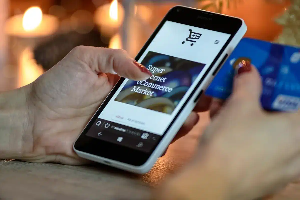 Smartphone scanning a promo code in a shopping app checkout