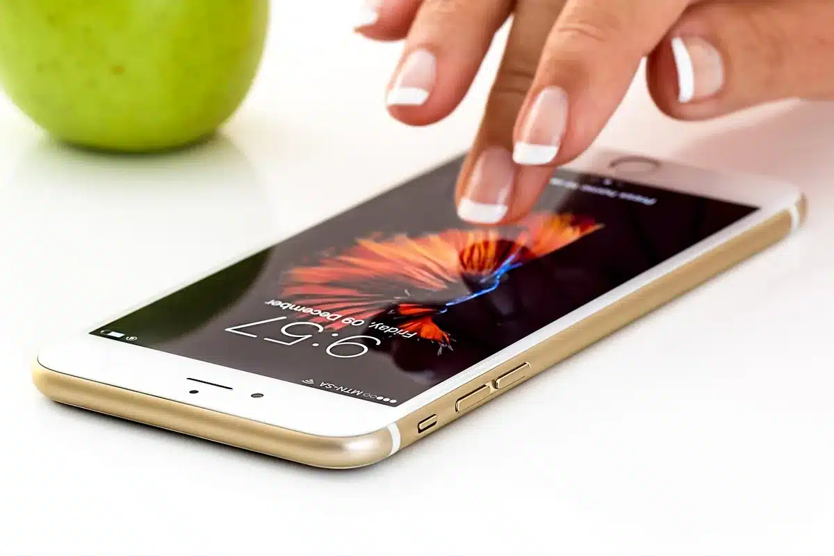 Hand holding generic spin tokens and a phone showing a spinning wheel on screen