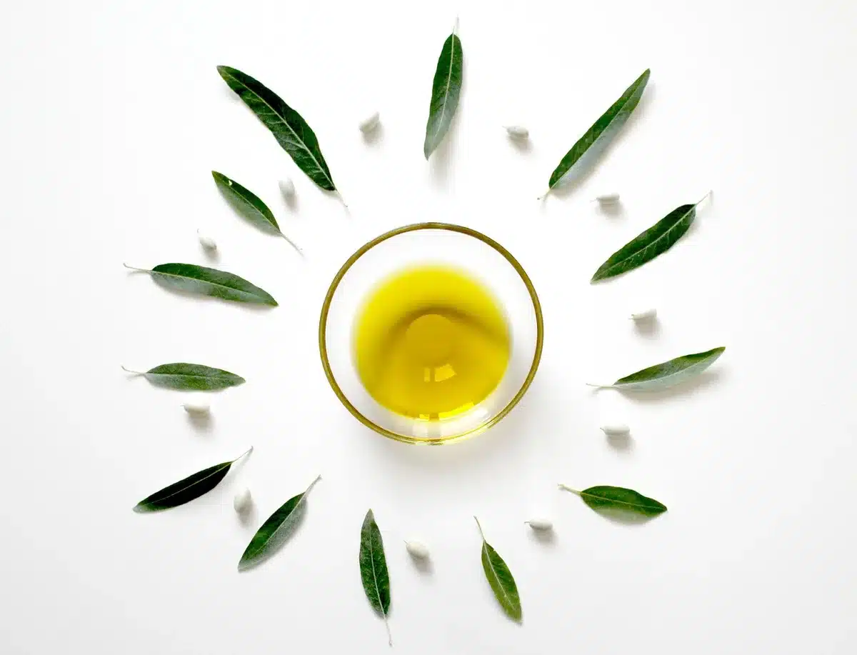 Olive oil on a clean mascara brush being applied to eyelashes