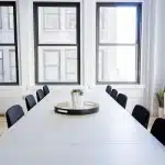 Hands exchanging generic casino chips on a table in a community meeting room